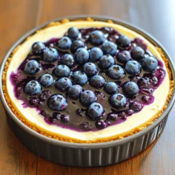 Für einen köstlichen No-Bake Blueberry Cheesecake benötigst du: - 1 ½ Tassen Graham-Cracker-Brösel - ¼ Tasse ungesalzene Butter, geschmolzen - 2 Tassen Frischkäse, weich - 1 Tasse Puderzucker - 1 Teelöffel Vanilleextrakt - 1 Tasse Schlagsahne - 2 Tassen frische Blaubeeren - 2 Esslöffel Zitronensaft - 1 Esslöffel Maisstärke - 1 Esslöffel Honig (optional) Diese Zutaten sind einfach zu finden. Der Frischkäse gibt dem Cheesecake seine Cremigkeit. Die Blaubeeren bringen Frische und Farbe. Falls du keine Graham-Cracker hast, kannst du auch andere Kekse verwenden. Butterkekse oder Digestive-Kekse sind gute Alternativen. Wenn du keinen Frischkäse magst, probiere Quark oder einen pflanzlichen Käse. Für eine vegane Option kannst du Kokoscreme verwenden. Verwende frische oder gefrorene Blaubeeren. Wenn du keine Blaubeeren magst, nimm Erdbeeren oder Himbeeren. Die Nährwerte eines Stücks Cheesecake sind ungefähr: - Kalorien: 300 - Fett: 20 g - Kohlenhydrate: 28 g - Zucker: 18 g - Protein: 4 g Dieser Kuchen ist eine leckere süße Belohnung. Du kannst ihn teilen oder für einen besonderen Anlass genießen. Schau dir das vollständige Rezept an, um deine No-Bake Blueberry Cheesecake-Kreation zu machen! Für die Kruste nehmen Sie 1 ½ Tassen Graham-Cracker-Brösel. Fügen Sie ¼ Tasse geschmolzene Butter hinzu. Rühren Sie die Mischung gut um. Drücken Sie die Mischung in eine 9-Zoll-Springform. Stellen Sie die Form in den Kühlschrank. Lassen Sie die Kruste fest werden, während Sie die Füllung machen. In einer großen Schüssel nehmen Sie 2 Tassen weichen Frischkäse. Schlagen Sie ihn mit einem Mixer, bis er glatt ist. Fügen Sie 1 Tasse Puderzucker und 1 Teelöffel Vanilleextrakt hinzu. Mixen Sie weiter, bis alles gut verbunden ist. In einer anderen Schüssel schlagen Sie 1 Tasse Schlagsahne, bis sich steife Spitzen bilden. Heben Sie die Schlagsahne vorsichtig unter die Frischkäsemischung. In einem kleinen Topf kombinieren Sie 2 Tassen frische Blaubeeren, 2 Esslöffel Zitronensaft und, falls gewünscht, 1 Esslöffel Honig. Fügen Sie 1 Esslöffel Maisstärke hinzu. Kochen Sie die Mischung bei mittlerer Hitze, während Sie leicht rühren. Nach etwa 5 Minuten sind die Blaubeeren weich. Nehmen Sie den Topf vom Herd und lassen Sie die Mischung abkühlen. Für die vollständige Zubereitung und alle Details schauen Sie sich das [Full Recipe](#) an. Ein häufiger Fehler ist, die Graham-Cracker-Kruste nicht richtig zu drücken. Wenn die Kruste locker ist, zerbricht der Käsekuchen beim Servieren. Achten Sie darauf, die Brösel fest und gleichmäßig auf dem Boden zu verteilen. Ein weiterer Fehler ist, die Sahne nicht steif genug zu schlagen. Die Schlagsahne gibt dem Käsekuchen seine luftige Textur. Übermixen Sie die Füllung nicht, da sie sonst zu flüssig wird. Für die perfekte Konsistenz ist es wichtig, den Frischkäse gut zu mixen. Er sollte weich und glatt sein, bevor Sie andere Zutaten hinzufügen. Verwenden Sie Raumtemperatur-Frischkäse, damit sich alles gut vermischt. Fügen Sie die Schlagsahne vorsichtig hinzu, um die Luftigkeit zu bewahren. Wenn die Füllung zu dick ist, können Sie etwas mehr Sahne unterheben. Für eine festere Konsistenz lassen Sie den Käsekuchen länger im Kühlschrank. Servieren Sie den Käsekuchen kühl, direkt aus dem Kühlschrank. Dekorieren Sie ihn mit frischen Blaubeeren und einem Spritzer der Blaubeersauce. Für einen besonderen Look können Sie Minzblätter hinzufügen. Nutzen Sie ein scharfes Messer, um saubere Stücke zu schneiden. Stellen Sie sicher, dass jeder Bissen etwas von der Blaubeersauce hat. So wird jeder Löffel zu einem Genuss. Weitere Ideen finden Sie im Full Recipe. {{image_4}} Du kannst den No-Bake Blueberry Cheesecake leicht abändern. Probiere andere Früchte aus! Erdbeeren, Himbeeren oder Pfirsiche sind tolle Alternativen. Diese Früchte bringen neue Geschmäcker und Farben. Für jeden Geschmack ist etwas dabei. Du kannst auch eine Mischung verwenden. Das macht den Kuchen bunt und fruchtig. Achte darauf, die Frucht gut zu pürieren, wenn du eine glatte Füllung magst. Wenn du glutenfrei leben möchtest, wähle glutenfreie Keksbrösel. Diese Brösel sind einfach zu finden. Du kannst auch eine Mischung aus Nüssen und Datteln verwenden. Das gibt dem Boden einen tollen Geschmack. Für vegane Optionen ersetze den Frischkäse durch einen veganen Frischkäse. Kokoscreme ist eine gute Wahl. Auch pflanzliche Sahne funktioniert gut. So kannst du den Käsekuchen vegan genießen! Die Basis des Käsekuchens ist wichtig. Du kannst mit verschiedenen Keksarten experimentieren. Vollkornkekse oder Schokoladenkekse geben einen anderen Geschmack. Wenn du einen keksfreien Boden magst, probiere Haferflocken oder zerdrückte Mandeln. Das gibt dem Käsekuchen eine andere Textur. Du hast viele Möglichkeiten, um kreativ zu sein. Lass deiner Fantasie freien Lauf! Für das beste Ergebnis, halte die Maße der Zutaten im Auge. Für mehr Infos zur Zubereitung schau dir das [Full Recipe] an. Um den No-Bake Blueberry Cheesecake frisch zu halten, lege ihn in den Kühlschrank. Verwende eine gut sitzende Frischhaltefolie oder einen luftdichten Behälter. So bleibt die Textur fest und der Geschmack bleibt intensiv. Stelle sicher, dass der Käsekuchen nicht mit anderen Lebensmitteln in Berührung kommt, um Gerüche zu vermeiden. Im Kühlschrank hält der Käsekuchen bis zu fünf Tage. Wenn du ihn länger aufbewahren möchtest, friere ihn besser ein. Nach ein paar Tagen kann die Kruste weich werden. Die Füllung bleibt jedoch lecker und cremig. Achte darauf, die frischen Blaubeeren erst kurz vor dem Servieren hinzuzufügen. Du kannst den Käsekuchen auch einfrieren. Schneide ihn in Stücke und lege sie in einen luftdichten Behälter. So ist es einfach, nur ein Stück zu nehmen, wenn du Lust darauf hast. Der Käsekuchen hält sich im Gefrierfach bis zu drei Monate. Zum Auftauen, lege die Stücke einfach in den Kühlschrank über Nacht. Dies bewahrt die Textur und den Geschmack. Wenn du noch mehr über die Zubereitung erfahren möchtest, schau dir das [Full Recipe](#) an. Ja, du kannst den Käsekuchen auch ohne Blaubeeren machen. Du hast viele Optionen. Du kannst Erdbeeren, Himbeeren oder Pfirsiche verwenden. Auch Mango kann eine tolle Wahl sein. Achte darauf, die Früchte gut zu pürieren. Das gibt dem Käsekuchen eine schöne Farbe und einen leckeren Geschmack. Der Käsekuchen muss mindestens vier Stunden im Kühlschrank sein. Am besten lässt du ihn über Nacht stehen. So wird er schön fest und die Aromen ziehen gut durch. Wenn du ihn länger im Kühlschrank lässt, bleibt er frisch und lecker. Falls du keinen Frischkäse hast, gibt es Alternativen. Du kannst Mascarpone oder griechischen Joghurt verwenden. Sie geben dem Käsekuchen auch eine cremige Textur. Für eine vegane Option nutze Cashewcreme oder pflanzlichen Frischkäse. Diese Alternativen machen deinen Käsekuchen ebenso lecker. Für das vollständige Rezept schaue dir die [Full Recipe] an. Der No-Bake Blueberry Cheesecake ist einfach und lecker. Wir haben die Hauptzutaten und ihre Alternativen erkundet. Die Schritt-für-Schritt-Anleitung zeigt, wie du die Kruste, die Füllung und die Sauce zubereitest. Tipps helfen dir, Fehler zu vermeiden und die Konsistenz zu perfektionieren. Zudem gibt es kreative Variationen und wichtige Hinweise zur Lagerung. Wichtig ist, dass du den Käsekuchen ganz nach deinem Geschmack anpassen kannst. Ich hoffe, du bist bereit, diesen einfachen, köstlichen Käsekuchen auszuprobieren!